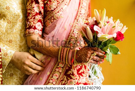 Indian Newlyweds Couple Hugging and bridal holding wedding flower bouquet Royalty-Free Stock Photo #1186740790