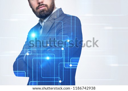 Unrecognizable bearded businessman standing with crossed arms in a white room with graphs holograms and hud. Hi tech concept. Toned image double exposure copy space film effect
