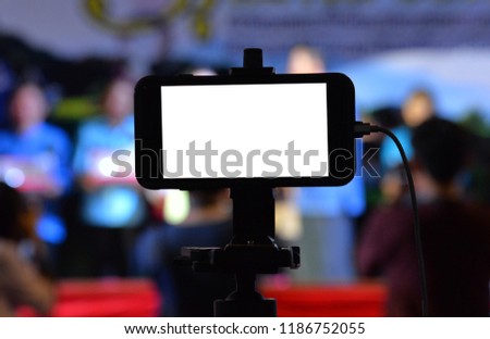 The use of mobile phones and tripod to record movies for events.