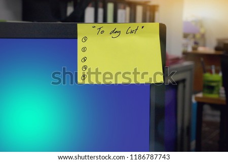 Sticky note with text to day list, checklist, on monitor.