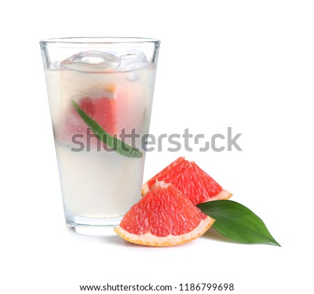 Glass of refreshing grapefruit lemonade on white background