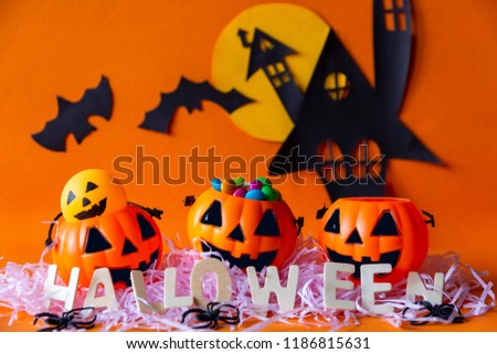 Happy Halloween with haunted house castle and pumpkins bucket and bat on orange background.Halloween theme