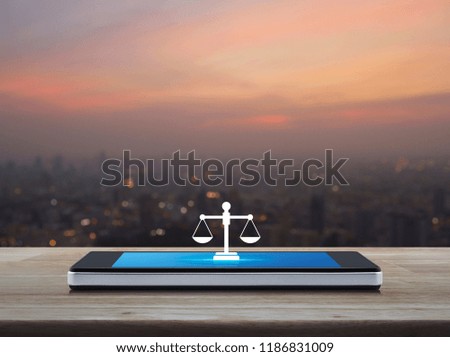 Law flat icon on modern smart mobile phone screen on wooden table over blur of cityscape on warm light sundown, Business legal service online concept