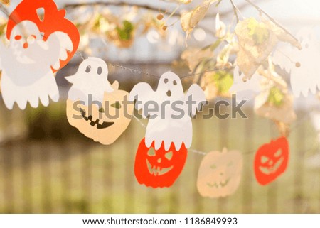 Happy Halloween. Greeting card. Celebration dark background with garland, pumpkin and spooky ghost