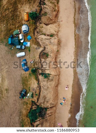 People rest on the wild beach with their families. Aerial photography