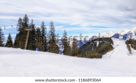 Unrecognizable skiers on beautiful ski slope in Alps