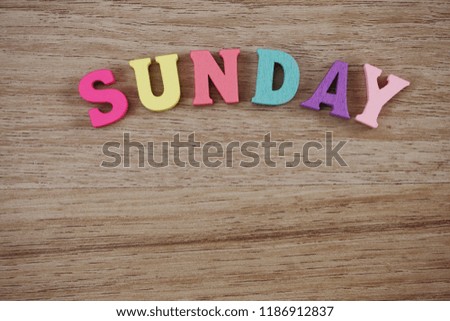 colorful sunday alphabet letters on wooden background