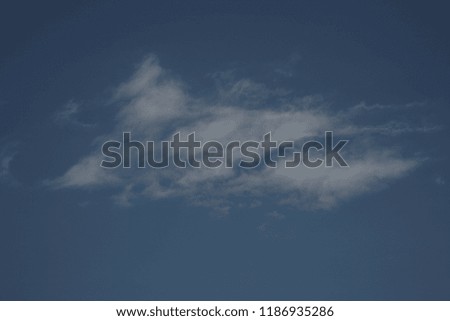 The inner glow of this cloud is almost not noticeable in the blue sky but creates a General view of the beautiful landscape in the expanses of heaven in calm weather