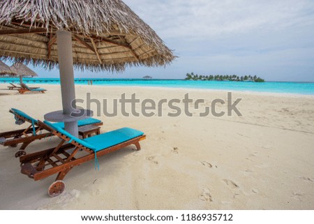The beach sun beds on luxury beach tropical island , Sanya, Hainan Province, China. Happy island lifestyle .