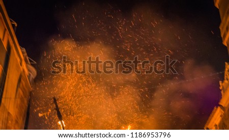 Fire flames with ashes against black night sky during final night la Crema at Las Fallas festival in Valencia Community, city of Cullera in Spain.