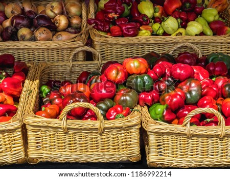 Baskets with bell peppers and other vegetables on the market Royalty-Free Stock Photo #1186992214