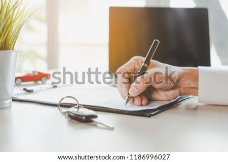 close up shots hands of client signing car lease form. Royalty-Free Stock Photo #1186996027