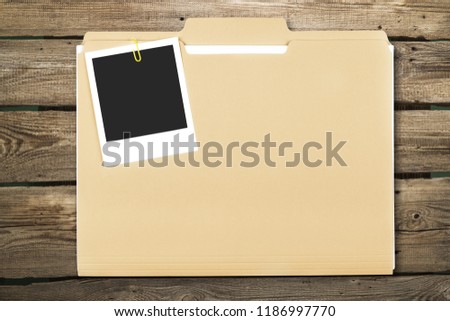 Blank photo on business folder on wooden