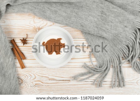 Macchiato or Latte Cappuccino on Rustic Wooden Background with 2019 New Year Pig Symbol. Holiday Mockup with Hot Coffee Cup and Piggy Silhouette on Cream Milk Foam Top View