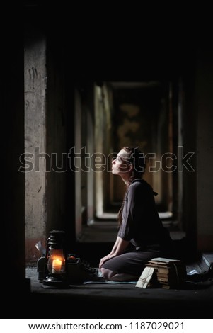 A young girl with old books in the old house
