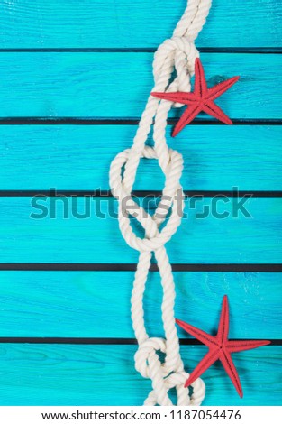Decorative Lifebuoy and anchor on blue wooden