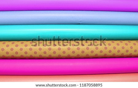 Rolls of colorful wrapping paper on white background 