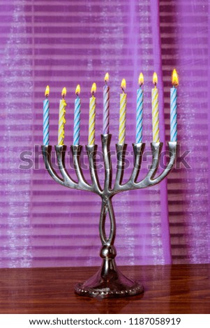 Lighting the brightly glowing Hanukkah menorah candles
