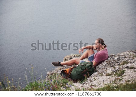 Attractive man enjoying the view of the mountains landscape above the water surface. Travel Lifestyle adventure vacations concept.