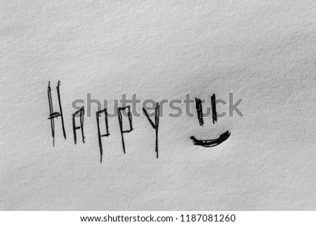 Black handwritten happy inscription with smile on the white paper. Happiness concept
