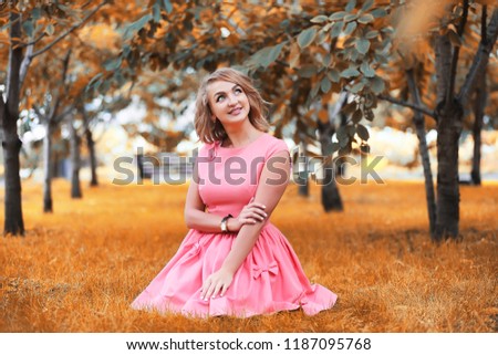 Beautiful girl in the park on a autumn sunny day walk