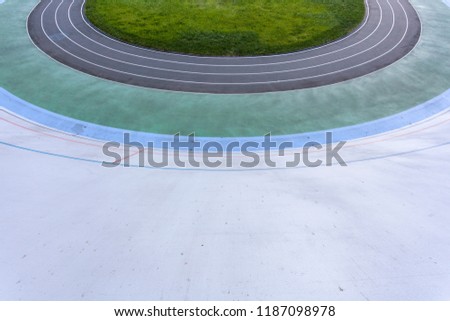 Track and field concept. High angle top view cropped photo of new empty modern public bicycle asphalt track in the open air with colored paths for practice, playing sports