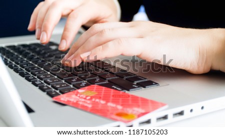 Closeup image of woman paying for online orders with credit card