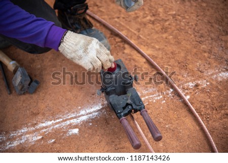 Connect copper grounding lightning protection system.Welding copper ground wire at construction site