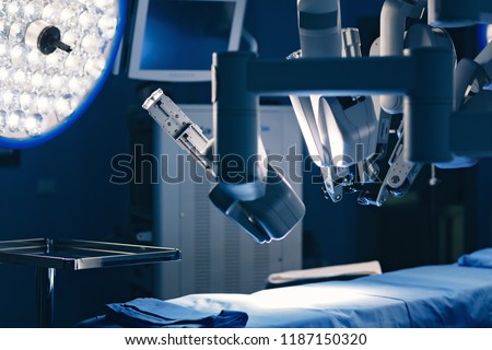 Surgical room in hospital with robotic technology equipment, machine arm surgeon in futuristic operation room. Minimal invasive surgical inoovation, medical robot surgery with 3D view endoscopy Royalty-Free Stock Photo #1187150320