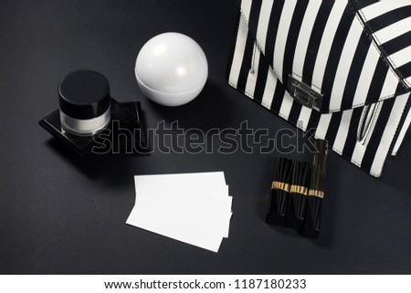 Makeup products. Black and white geometry. With blank business card