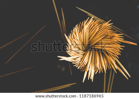 A lot of wooden toothpicks. Toothpick on a black background. 