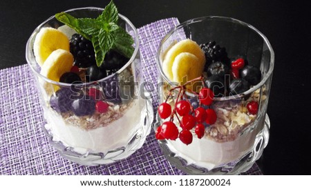 Delicious dessert in a glass.Cereals from the five cereals with yoghurt,banana and fresh berries.