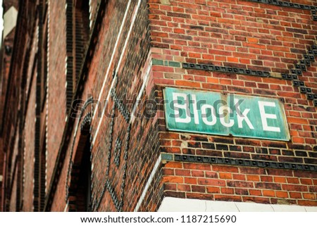 Image of a street sign on the building. Close up