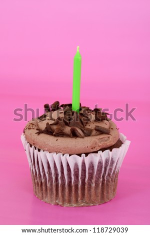 Chocolate cupcake focus on candle