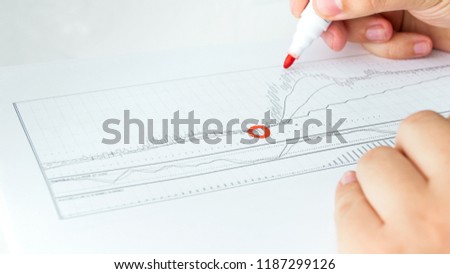 Closeup photo of businessman marking important points of financial activity graph