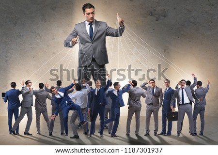 Boss employee manipulating his staff in business concept Royalty-Free Stock Photo #1187301937