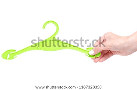 Green plastic hanger in hand on white background isolation