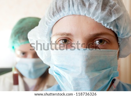 two young doctors in mask at clinic