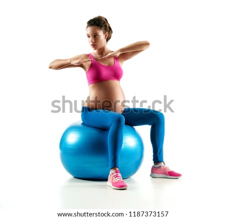 Pregnant woman exercising on fitball isolated on white background. Concept of healthy life