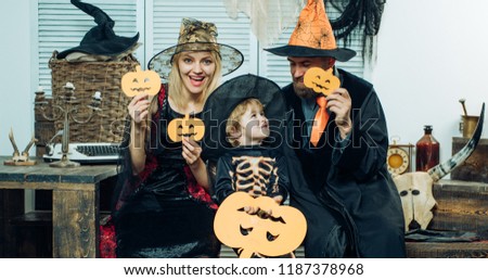 Autumn. Happy halloween! Magic hat. Pumpkin family concept. Happy family mother father and children in costumes and makeup on a celebration of Halloween