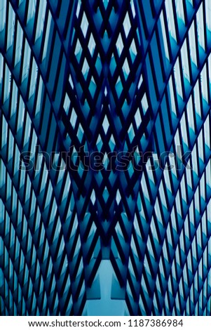 Reworked close-up photo of metal grid structure. Abstract metallic framework background on the subject of modern architecture, building exterior, construction industry or technology.