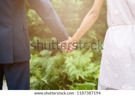 Man and woman hands holding together. Closeup view of married couple holding hands.