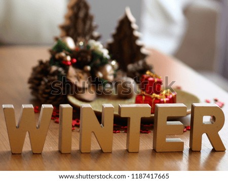 christmas table decoration with letters winter and defocused christmas ornaments in the background