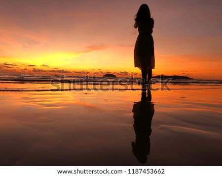 Chinese tourist on the beach during sunsets capture for photo