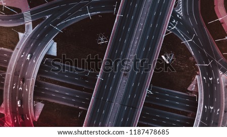 Aerial drone footage - high view with copter moving above three-level interchange highway and road junction with large cars traffic. Transport concept shoot with Minsk high road. Royalty-Free Stock Photo #1187478685