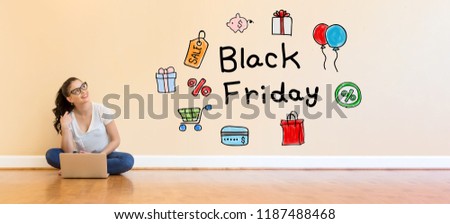 Black Friday text with young woman using a laptop computer on floor