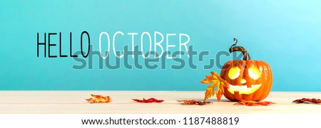 Hello October messag with pumpkin with leaves on a blue background