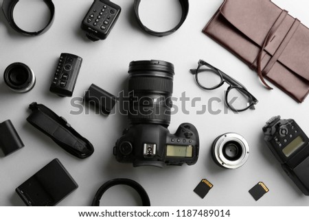 Flat lay composition with professional photographer equipment on light background