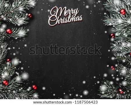 Upper, top, view from above, evergreen branches, tree globes and white Merry Christmas inscription on black background, with space for text writing, greeting. Royalty-Free Stock Photo #1187506423