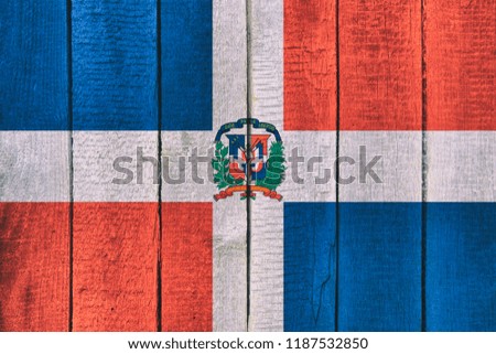 Old  wooden table texture background top view  with a National Flag of Dominican Republic. Dominicanian Flags image.